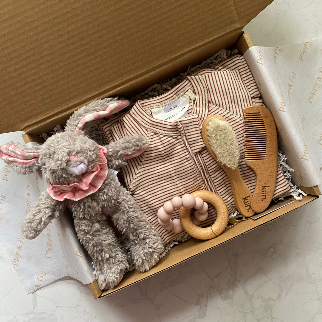 Baby gift set with plush toy, onesie and baby care items in a box 